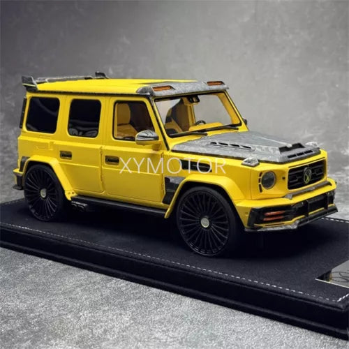 Mansory 1/18 diecast Mercedes G63 AMG model car, yellow SUV with front view on stand