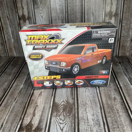 Diecast Ford F-150 truck model kit box with orange pickup artwork