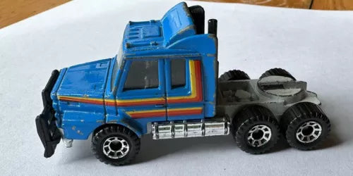 Blue diecast semi truck cab with black wheels