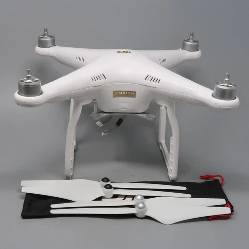White quadcopter drone with four propellers and DJI Phantom 3 body, front underside open.