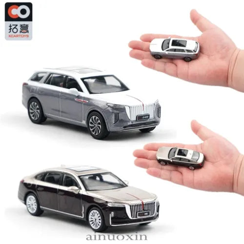 Gray SUV diecast car model, front three-quarter view, held in a hand