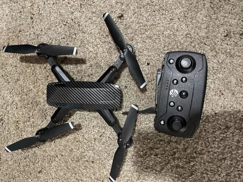Black quadcopter drone with remote controller