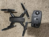 Black quadcopter drone with remote controller