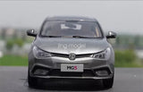 Grey MG5 die-cast model car, front view, MG logo and grille