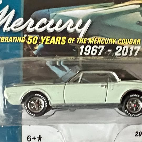 Mint green diecast sports car model with chrome wheels and side profile view