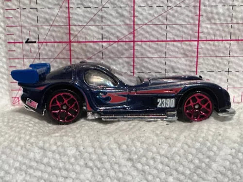 Blue and black diecast race car with red wheels and side graphics