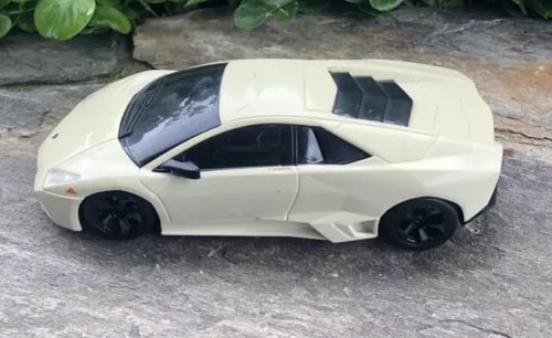 Ivory 1:24 scale diecast sports car model with black wheels and side vents