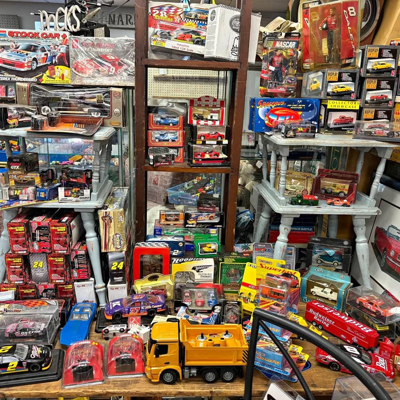 Diecast car and truck collection display with multiple toy vehicles in boxes