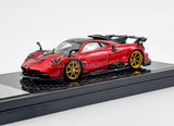 Red 1:64 scale diecast sports racing car with gold wheels and rear spoiler