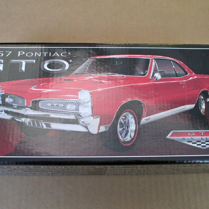 Red 1967 Pontiac GTO 1:24 diecast model car with chrome front grille detail