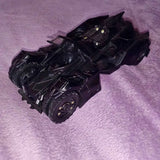 Black diecast Batmobile toy car with detailed wheels and cockpit