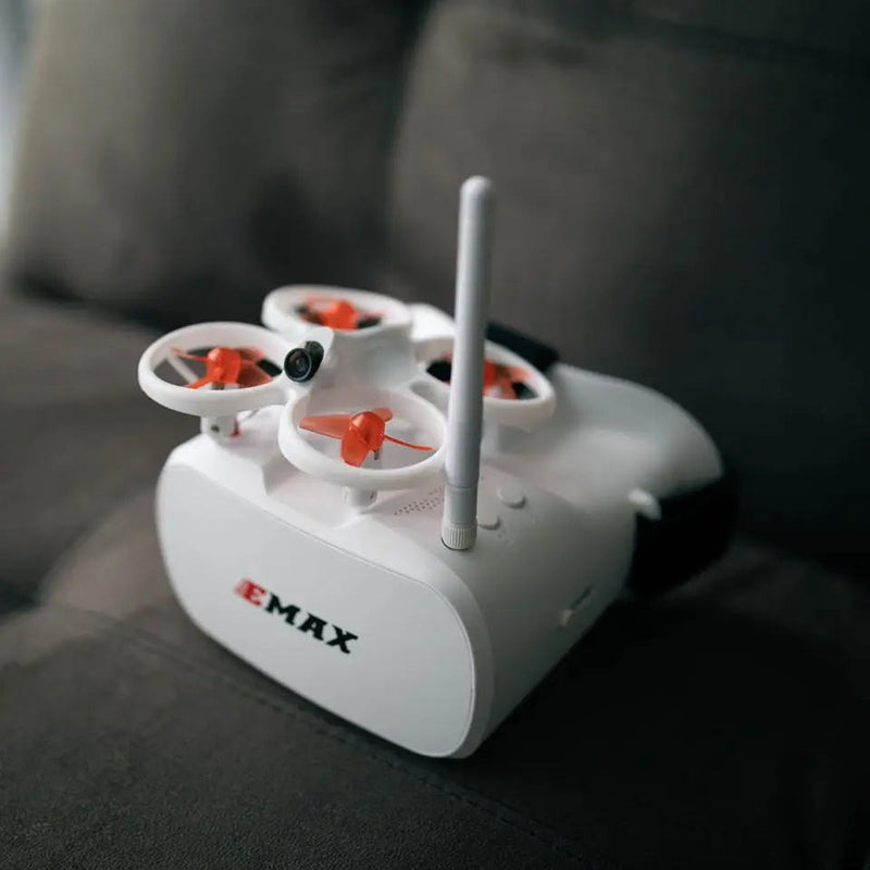 Mini FPV racing drone, white with orange propellers and long antenna
