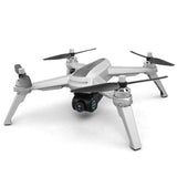 Quadcopter drone with front camera, four propellers, and grey body.