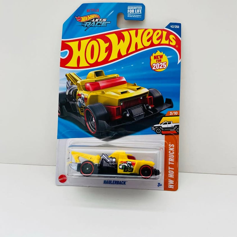Yellow Haulerback diecast truck in blister pack, black wheels and red accents