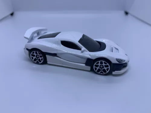 White die-cast sports car with black hood and tinted windows, 1:64 scale