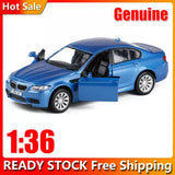 Blue 1:36 diecast model car, front and side view with open driver door