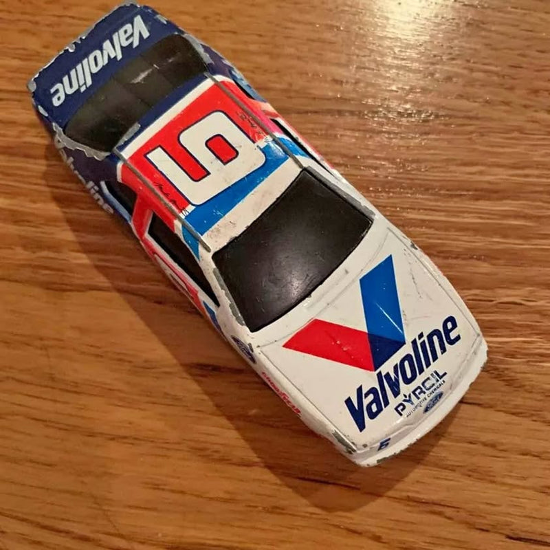 1:64 NASCAR diecast race car, Valvoline livery with large #10 on hood.