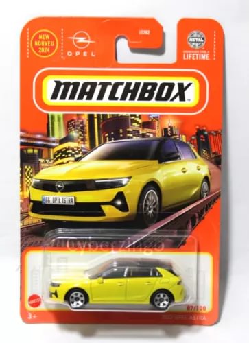 Yellow diecast model car (Opel Astra) in blister retail package