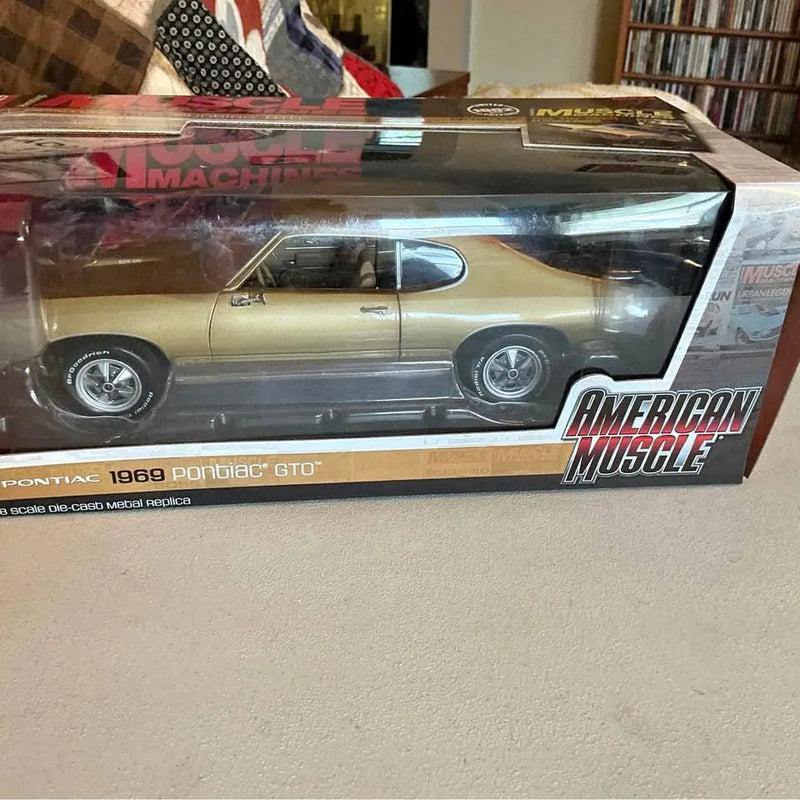 1:18 scale 1969 Pontiac GTO diecast car model in retail box, tan