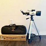 Refracting telescope with blue tripod stand and carrying bag