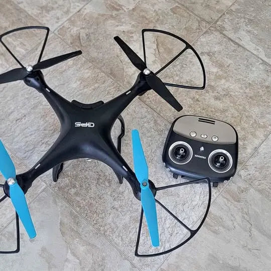 Converse TX drone with four propellers and handheld controller