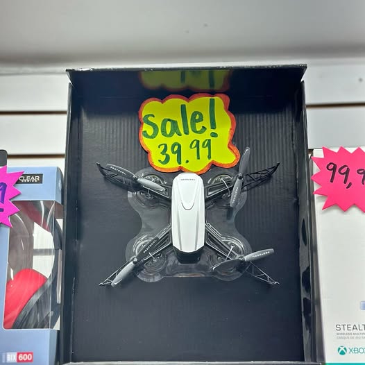 Drone in retail box with folded quadcopter and “Sale! 39.99” sticker