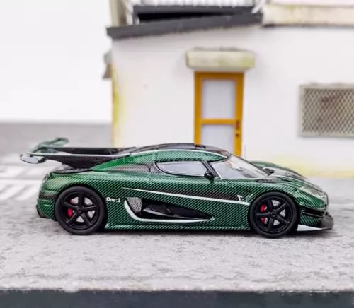 Green racing car diecast model with black wheels, side view