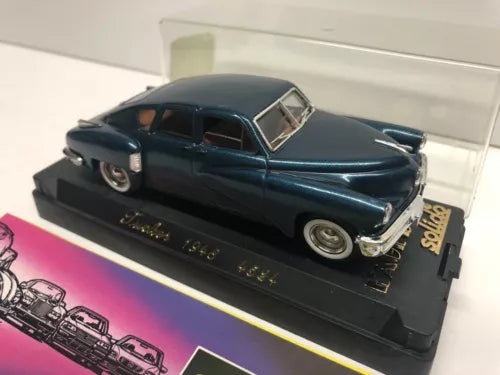 Dark blue 1948 Tucker diecast car model with open hood on display base