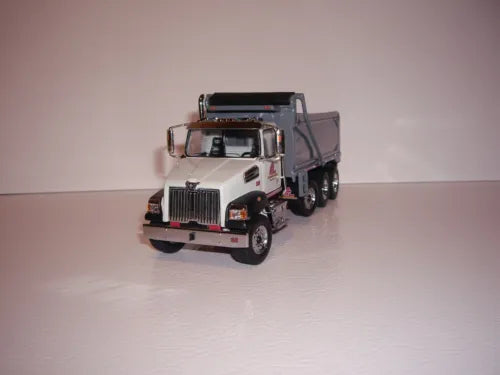 White diecast tri-axle dump truck with black grille and front cab details