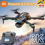 Black-and-gray quadcopter drone with blue lights and dual camera; handheld controller