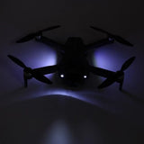 RC quadcopter drone with four propellers and blue LED lights on the body