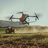 Agricultural pesticide spraying drone with large tank, orange frame and quad rotors