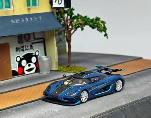 Blue 1:64 sports racing diecast model car with detailed front and silver wheels