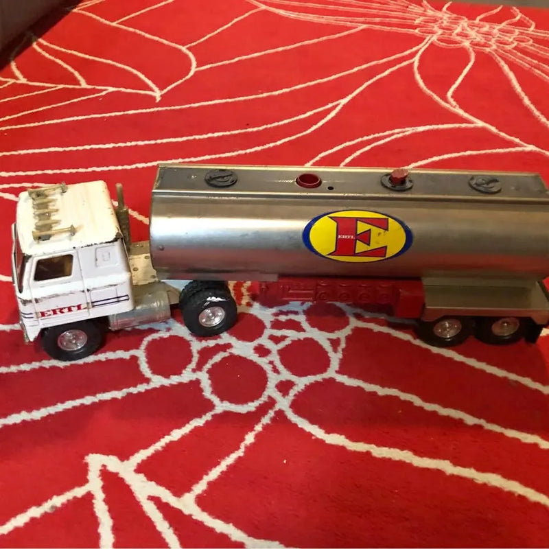 White cabover semi truck tanker diecast model with silver tank and red wheels
