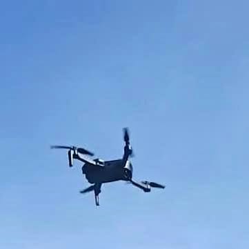 Quadcopter drone in flight with four propellers