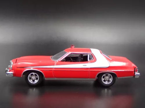 Red and white diecast model car, 1976 Gran Torino, side view