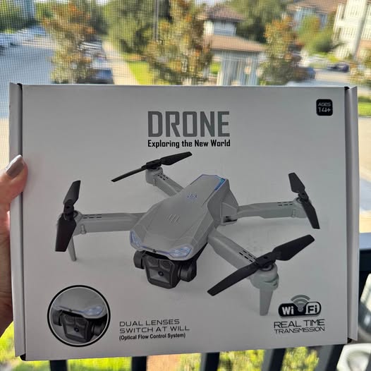Drone with camera box showing white quadcopter with camera and four propellers