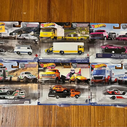 Hot Wheels diecast car assortment in clear blister packs with visible red, yellow, and black cars