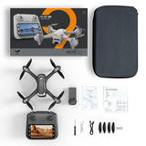 Quadcopter drone with controller screen and propellers, plus accessory manuals and parts