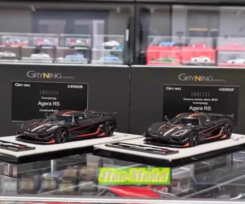 Black diecast model car with red stripe accents, shown in box display