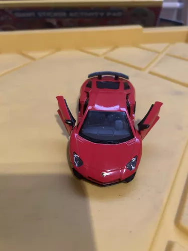 Red 1/36 scale diecast toy car, front view with upward doors open.