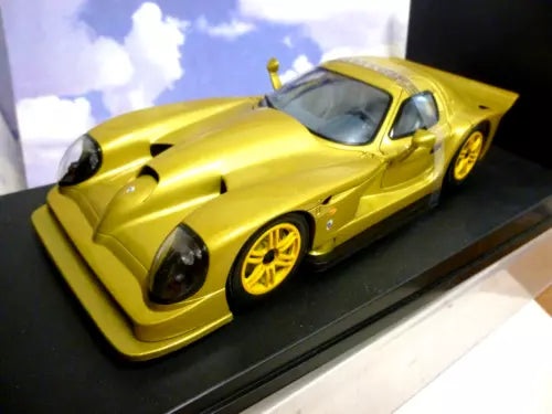 Gold diecast street car model with black accents, front 3/4 view.