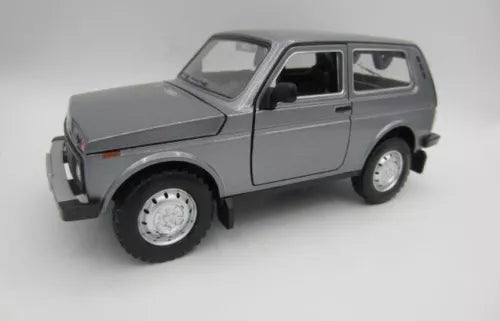 Gray metal diecast retro car model with side doors and black tires, 1:18 scale