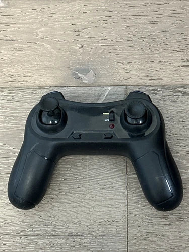 Black quadcopter game controller with twin thumbsticks and center buttons