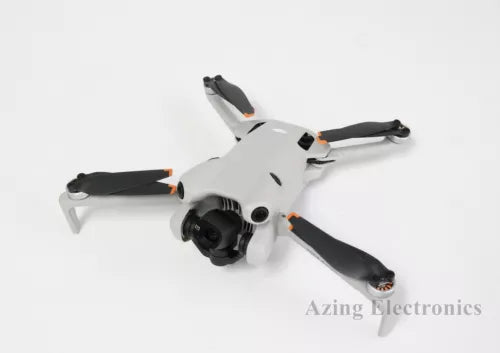 DJI Mini 4 Pro drone with white body, black propellers, and front camera