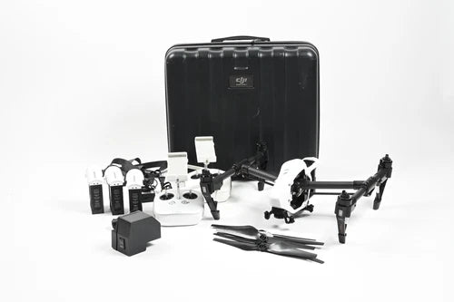Quadcopter drone kit with black case, camera gimbal, propellers, and batteries