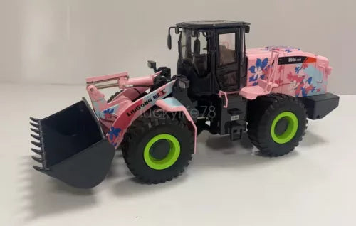 Pink and black diecast wheel loader model with front bucket and green wheels