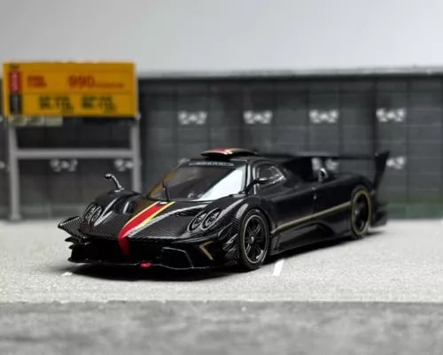 Black sports model diecast race car with red stripe, front 3/4 view