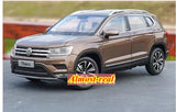 Brown Volkswagen Tharu diecast SUV model car, front 3/4 view with chrome grille