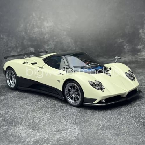 Diecast model sports car, light yellow/white with black accents, front three-quarter view.